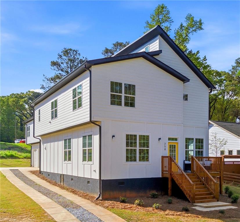 358 St Johns Avenue Southwest Atlanta, GA 30315 - Photo 2 of 35 a front view of a house with a yard