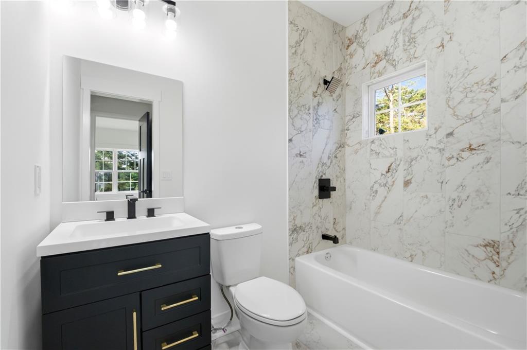 358 St Johns Avenue Southwest Atlanta, GA 30315 - Photo 22 of 35 a bathroom with a sink a toilet and shower