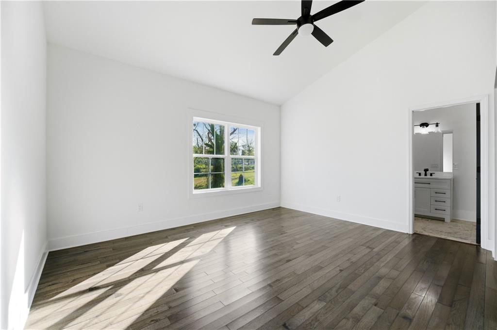 358 St Johns Avenue Southwest Atlanta, GA 30315 - Photo 23 of 35 an empty room with wooden floor and windows