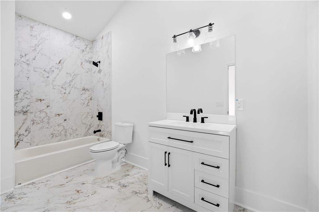 358 St Johns Avenue Southwest Atlanta, GA 30315 - Photo 24 of 35 a bathroom with a sink a toilet and a bathtub