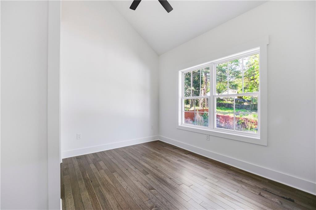 358 St Johns Avenue Southwest Atlanta, GA 30315 - Photo 34 of 35 an empty room with wooden floor and windows