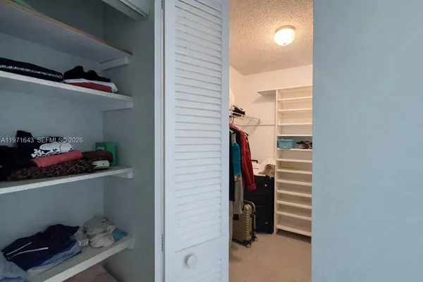 a view of hallway with cabinet and stairs