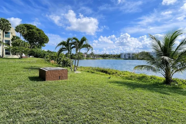 a view of a garden with a building in the background