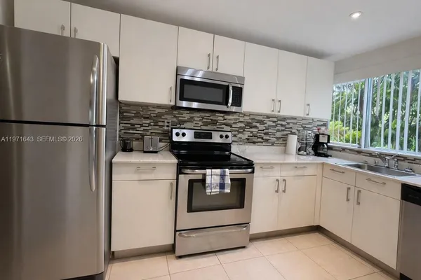 a kitchen with a stove microwave and refrigerator