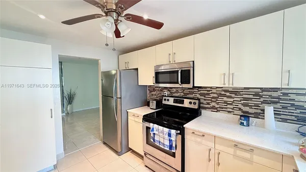 a kitchen with a stove and a microwave