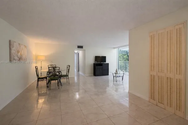 a dining room with furniture and a kitchen