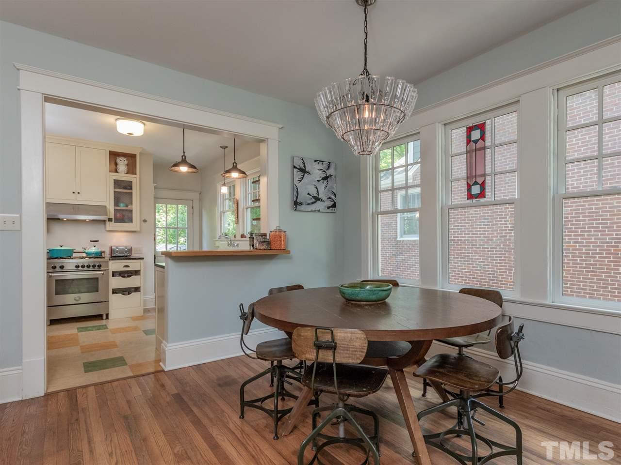 517 Washington Street Raleigh, NC 27605 - Photo 12 of 30 a view of a dining room with furniture wooden floor and a chandelier