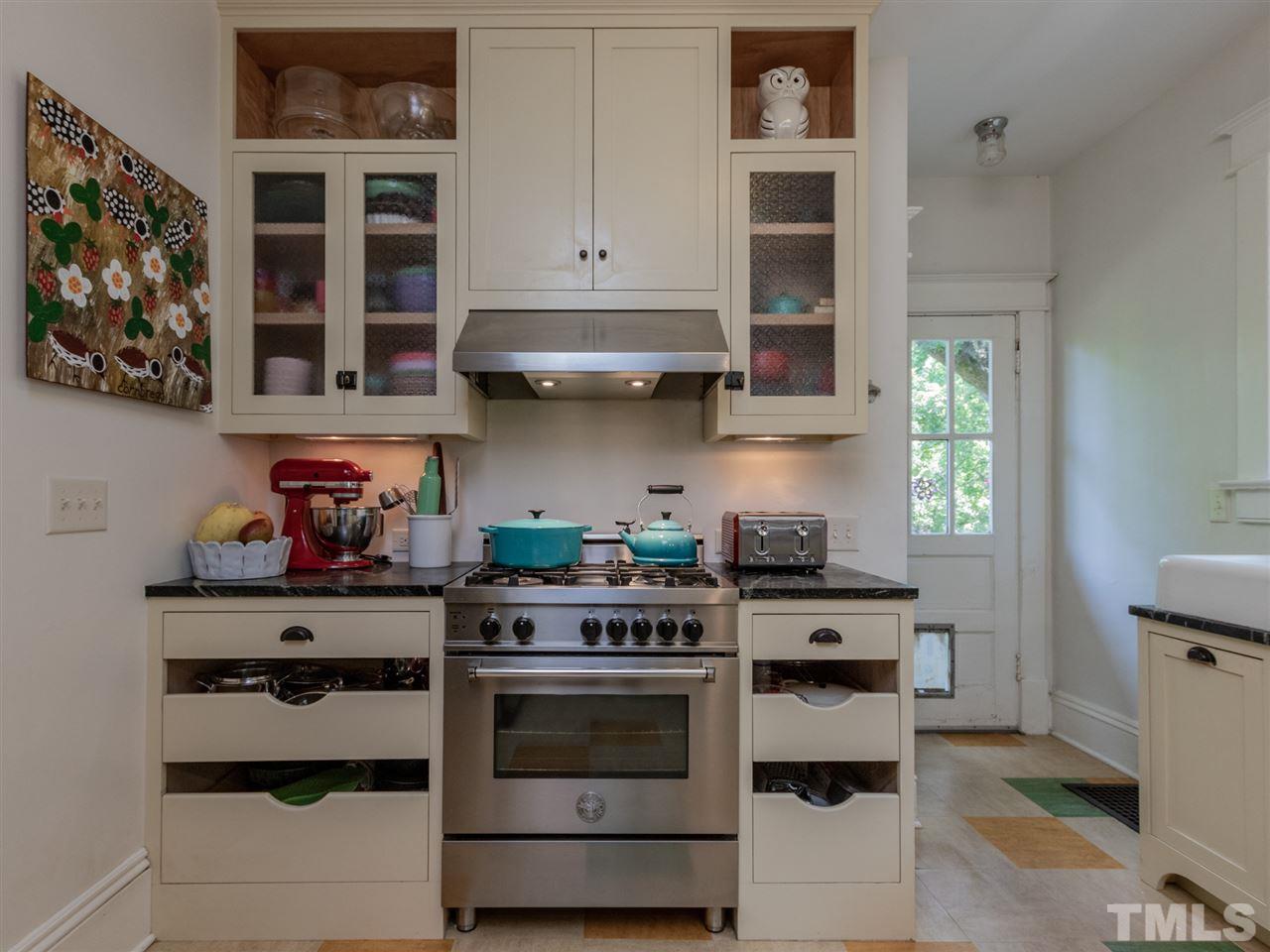 517 Washington Street Raleigh, NC 27605 - Photo 14 of 30 a kitchen with stainless steel appliances granite countertop a stove and cabinets