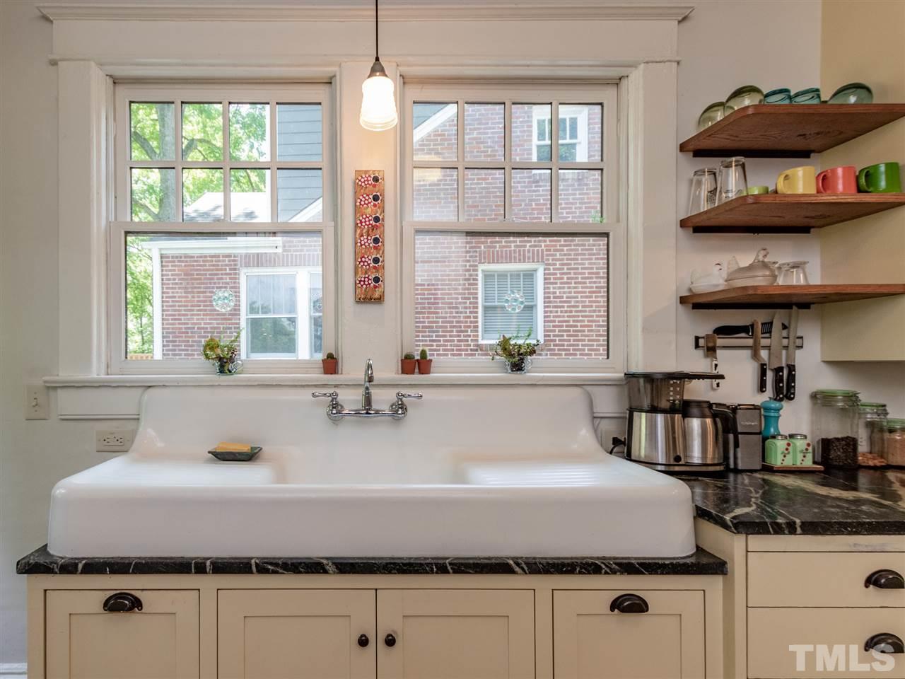 517 Washington Street Raleigh, NC 27605 - Photo 15 of 30 a bathroom with a granite countertop sink a large window and a mirror