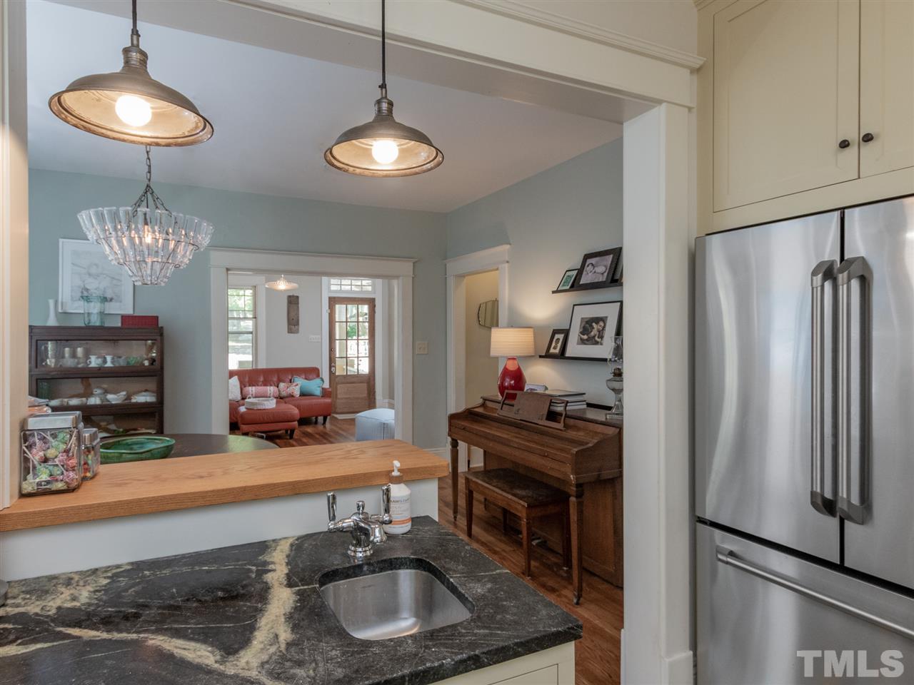 517 Washington Street Raleigh, NC 27605 - Photo 19 of 30 a kitchen with refrigerator and a wooden floor