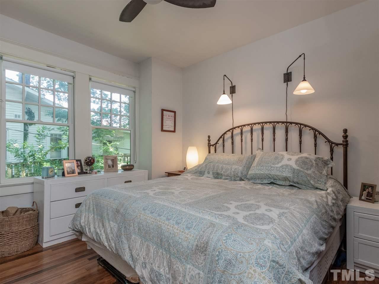 517 Washington Street Raleigh, NC 27605 - Photo 20 of 30 a large bed sitting in a bedroom next to a window