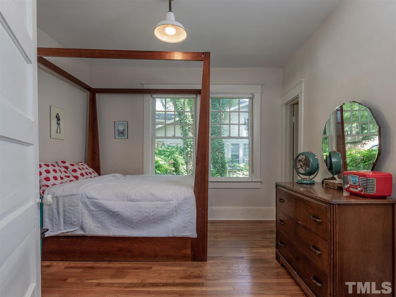 517 Washington Street Raleigh, NC 27605 - Photo 21 of 30 a bedroom with a bed and large windows