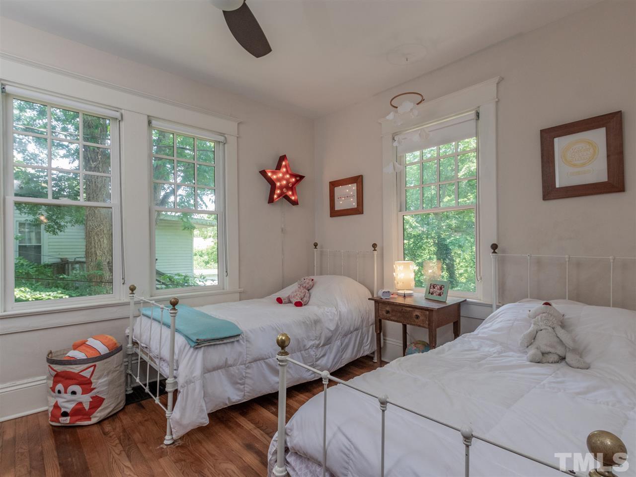 517 Washington Street Raleigh, NC 27605 - Photo 22 of 30 a bedroom with two beds and a window
