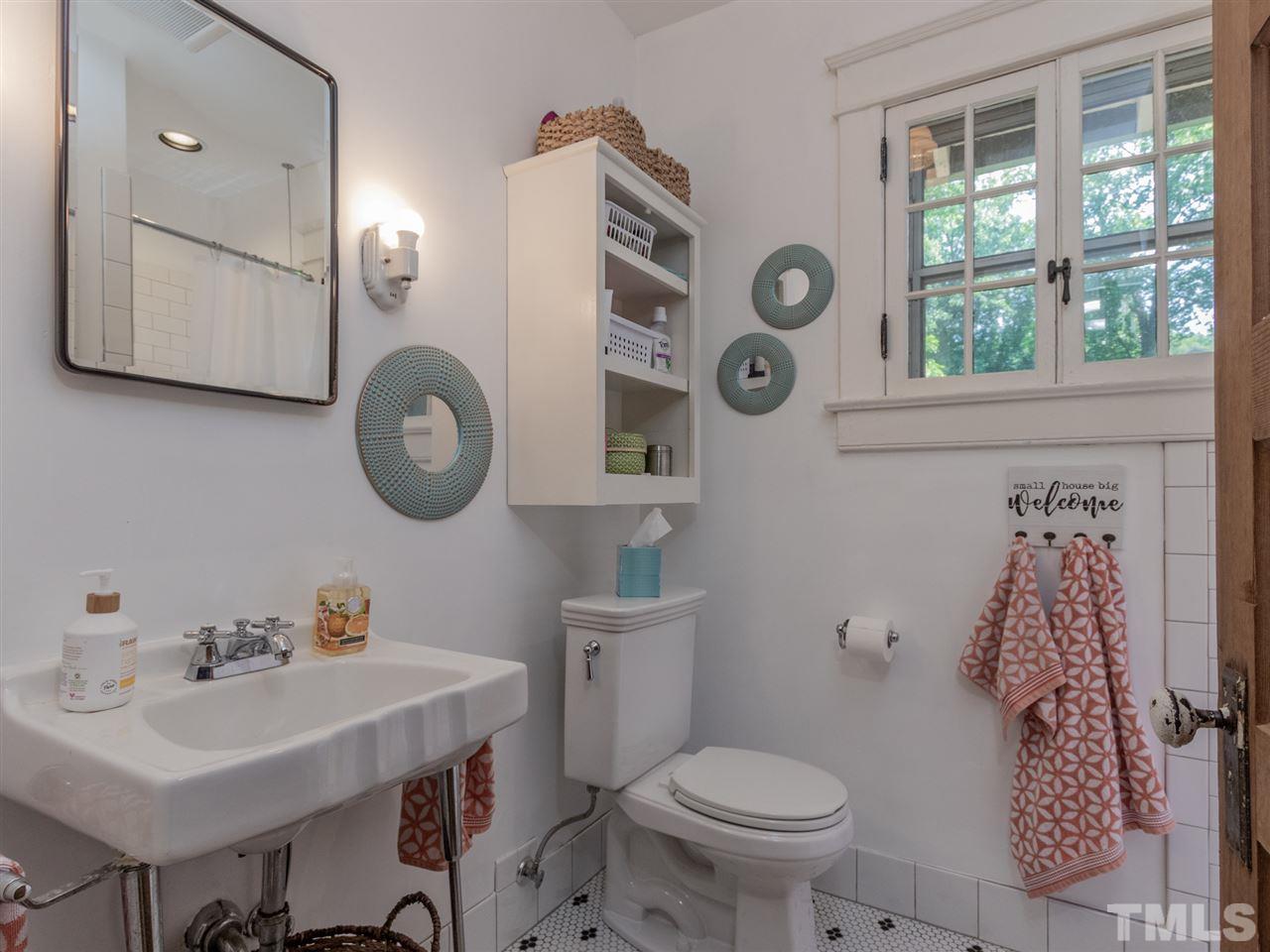 517 Washington Street Raleigh, NC 27605 - Photo 23 of 30 a bathroom with a toilet a sink and a mirror