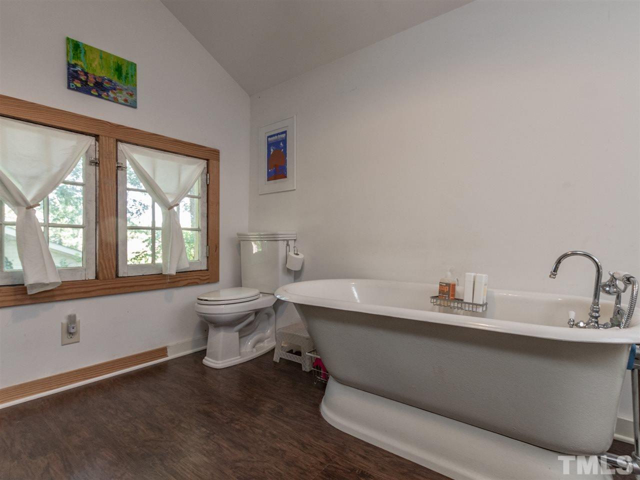 517 Washington Street Raleigh, NC 27605 - Photo 26 of 30 a bathroom with a sink and a large mirror