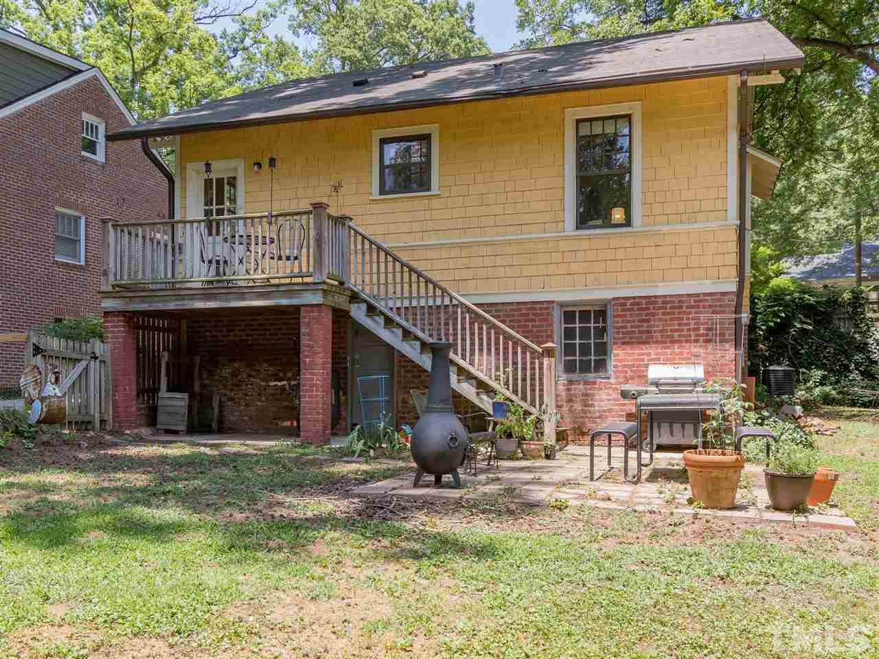 517 Washington Street Raleigh, NC 27605 - Photo 29 of 30 a view of a house with a patio and a yard