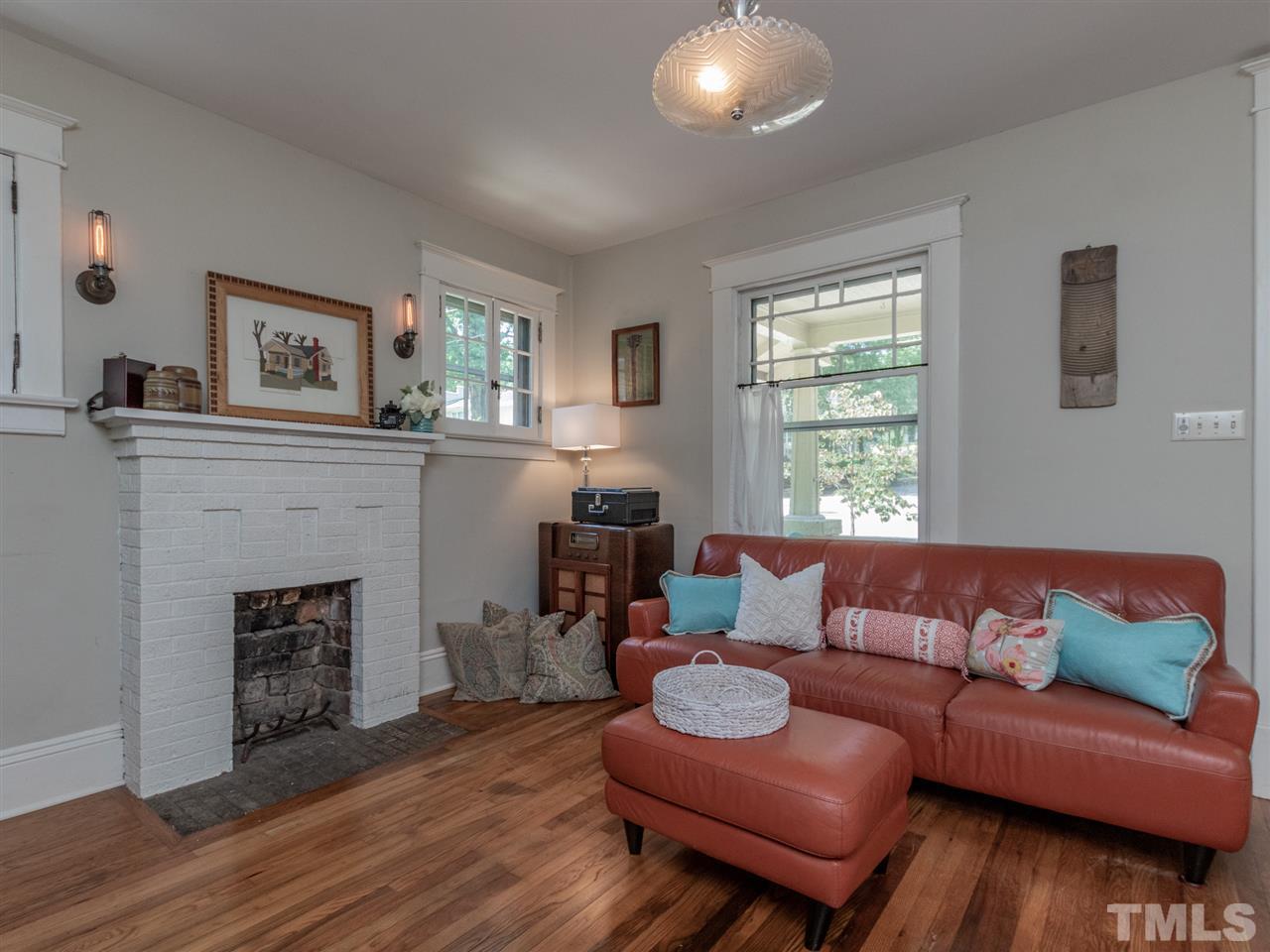 517 Washington Street Raleigh, NC 27605 - Photo 10 of 30 a living room with furniture and a fireplace