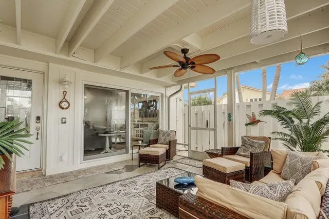 a living room with furniture ceiling fan and a rug