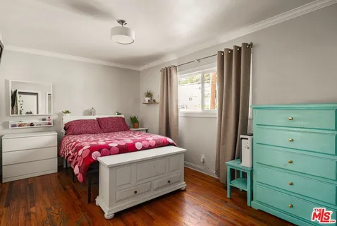 a bedroom with a bed and a dresser