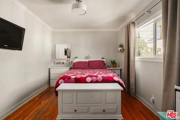a bedroom with a bed and flat screen tv