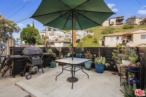 a view of a patio with furniture and a umbrella