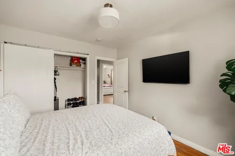a bedroom with a bed and a flat screen tv