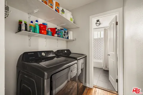 a utility room with sink dryer and washer