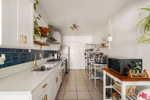 a kitchen with stainless steel appliances a sink a stove and a refrigerator