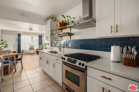 a kitchen with cabinets and window