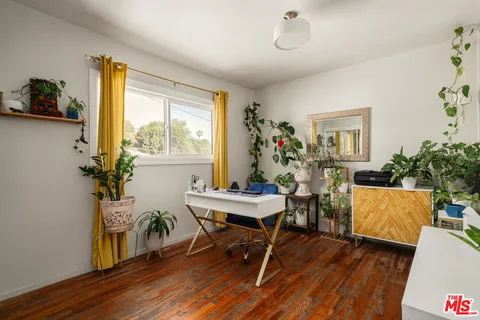a workspace with furniture window and wooden floor