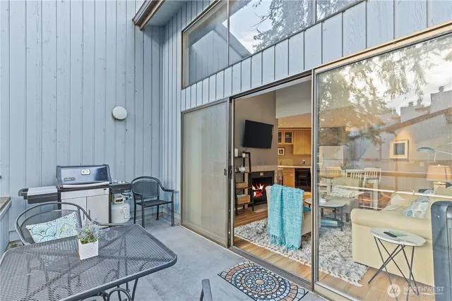 a balcony with chairs and table in wooden floor