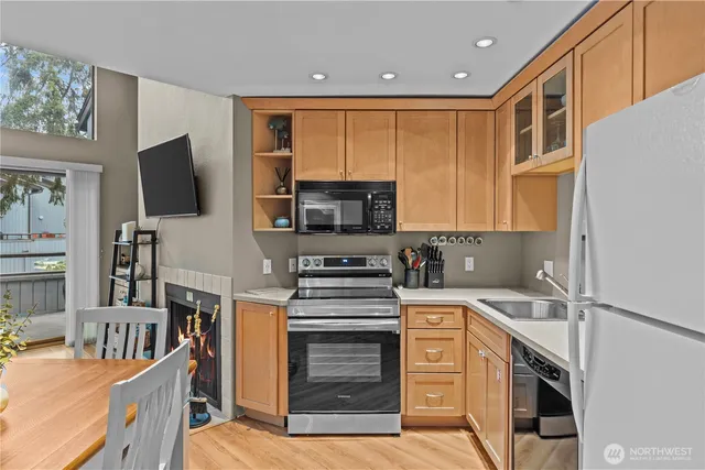a kitchen with stainless steel appliances granite countertop a stove and a microwave
