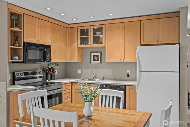 a kitchen with a refrigerator stove top oven and sink