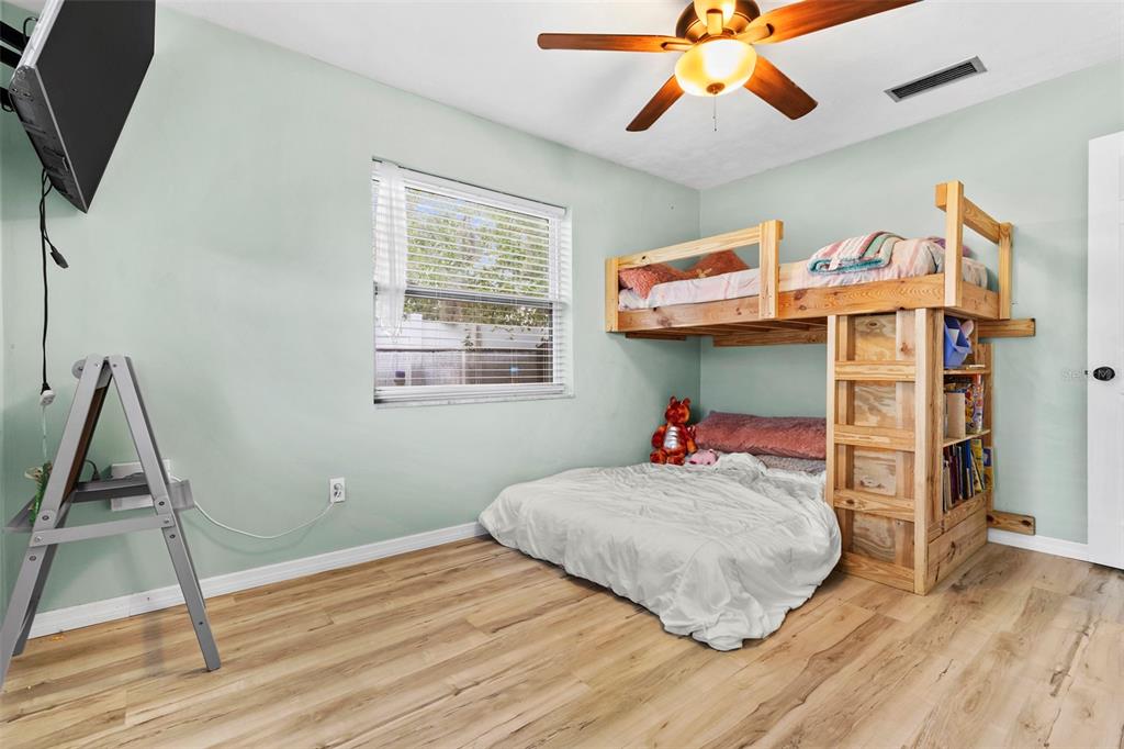 6221 Dalton Street Spring Hill, FL 34606 - Photo 19 of 40 a bedroom with a bed and wooden floor