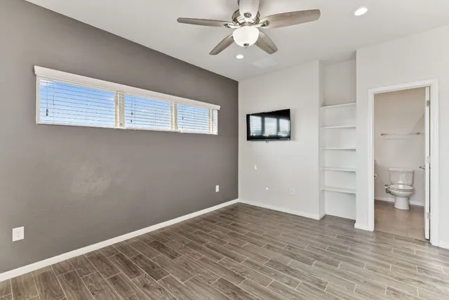 wooden floor in an empty room with a window