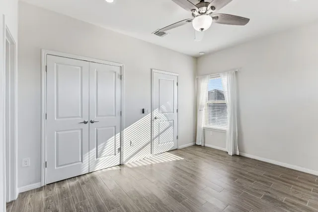 wooden floor with white walls and windows in a room