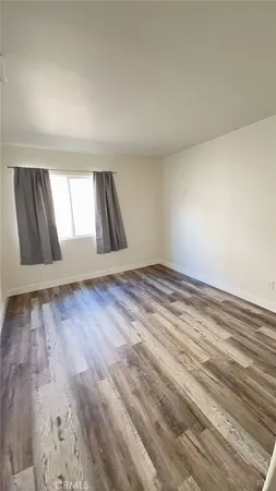 a view of an empty room and wooden floor