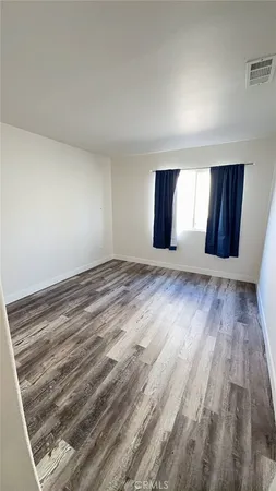 a view of wooden floor and windows in a room