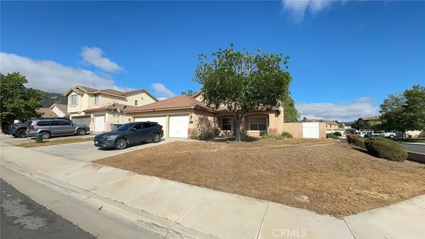 a yellow house with trees in front of it