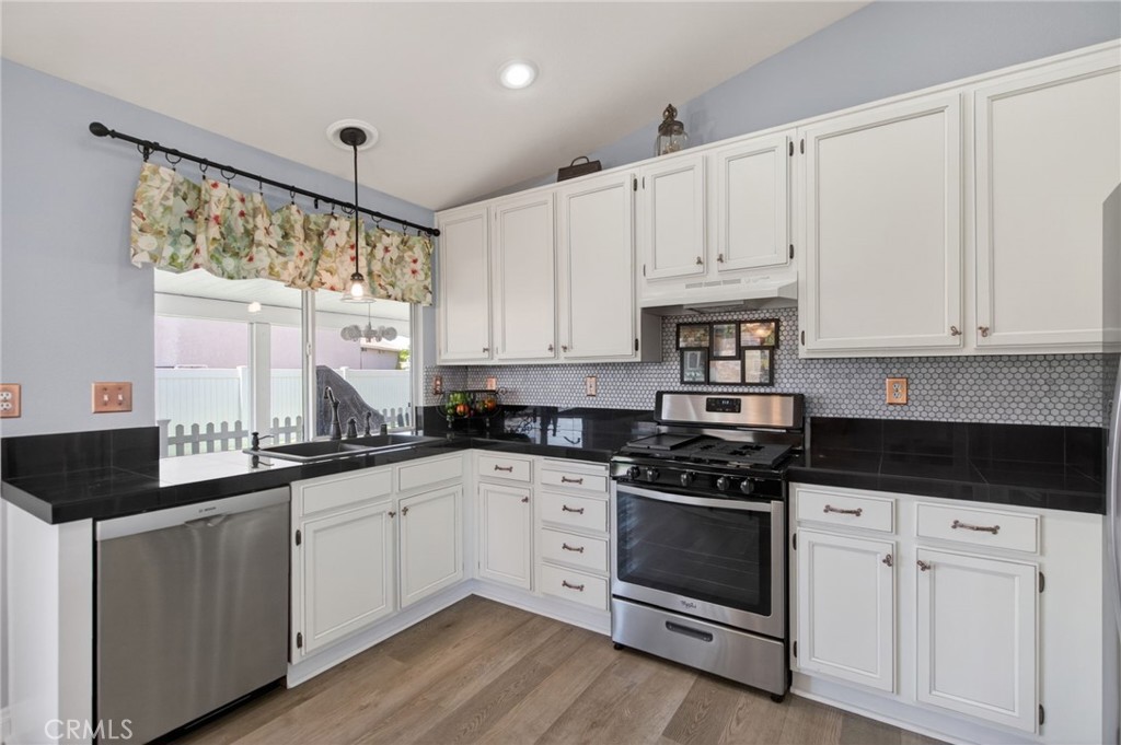 19584 Jill Court Riverside, CA 92508 - Photo 8 of 31 a kitchen with white cabinets and appliances