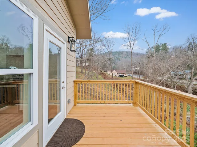 a view of balcony with wooden floor