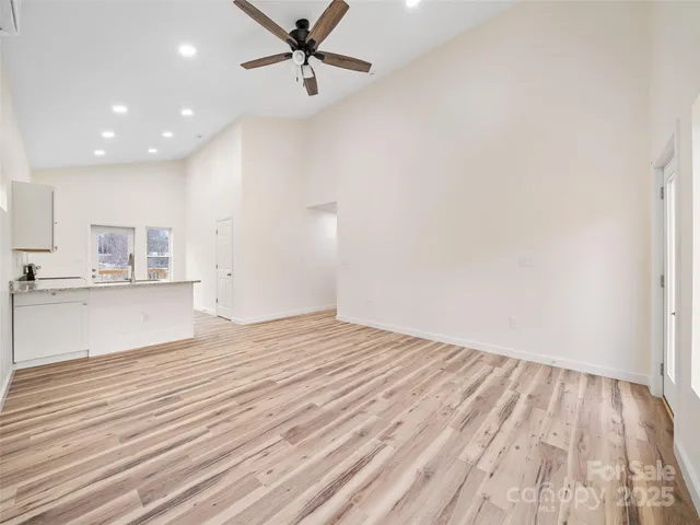 a view of a kitchen with wooden floor and a sink