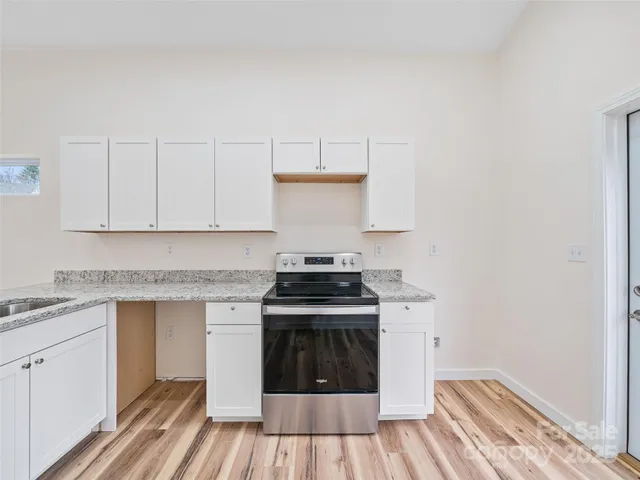 a stove top oven sitting inside of a kitchen