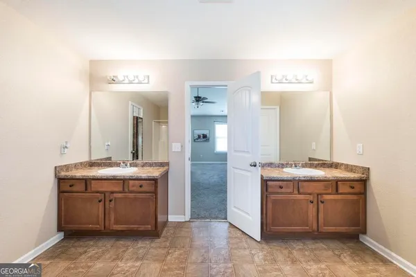 a view of bathroom with mirror and sink