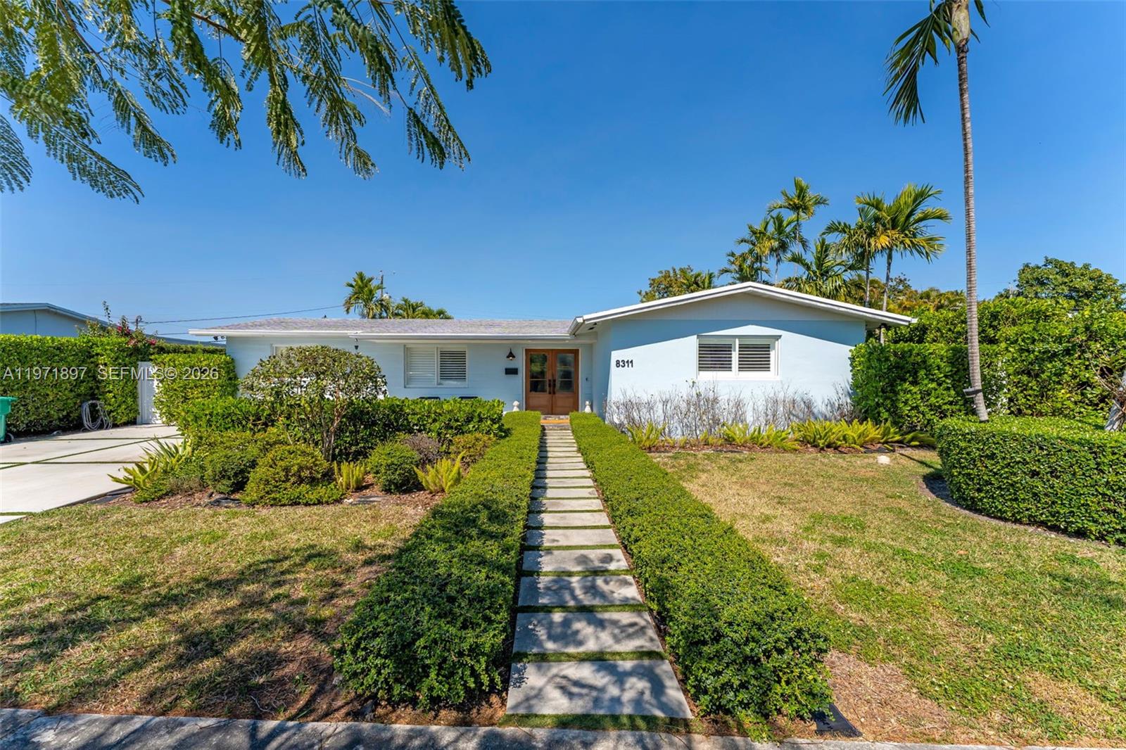 8311 Southwest 47th Street Miami, FL 33155 - Photo 1 of 48 a front view of a house with a yard
