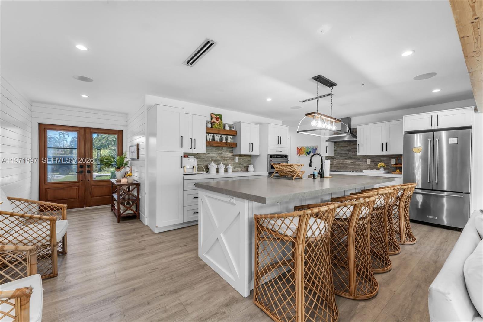 8311 Southwest 47th Street Miami, FL 33155 - Photo 14 of 48 a kitchen with stainless steel appliances granite countertop a refrigerator a sink dishwasher a stove and white cabinets with wooden floor