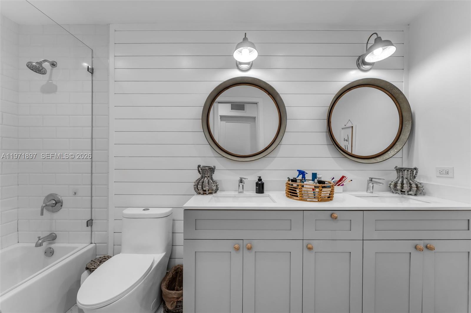 8311 Southwest 47th Street Miami, FL 33155 - Photo 17 of 48 a bathroom with a toilet a sink and a mirror