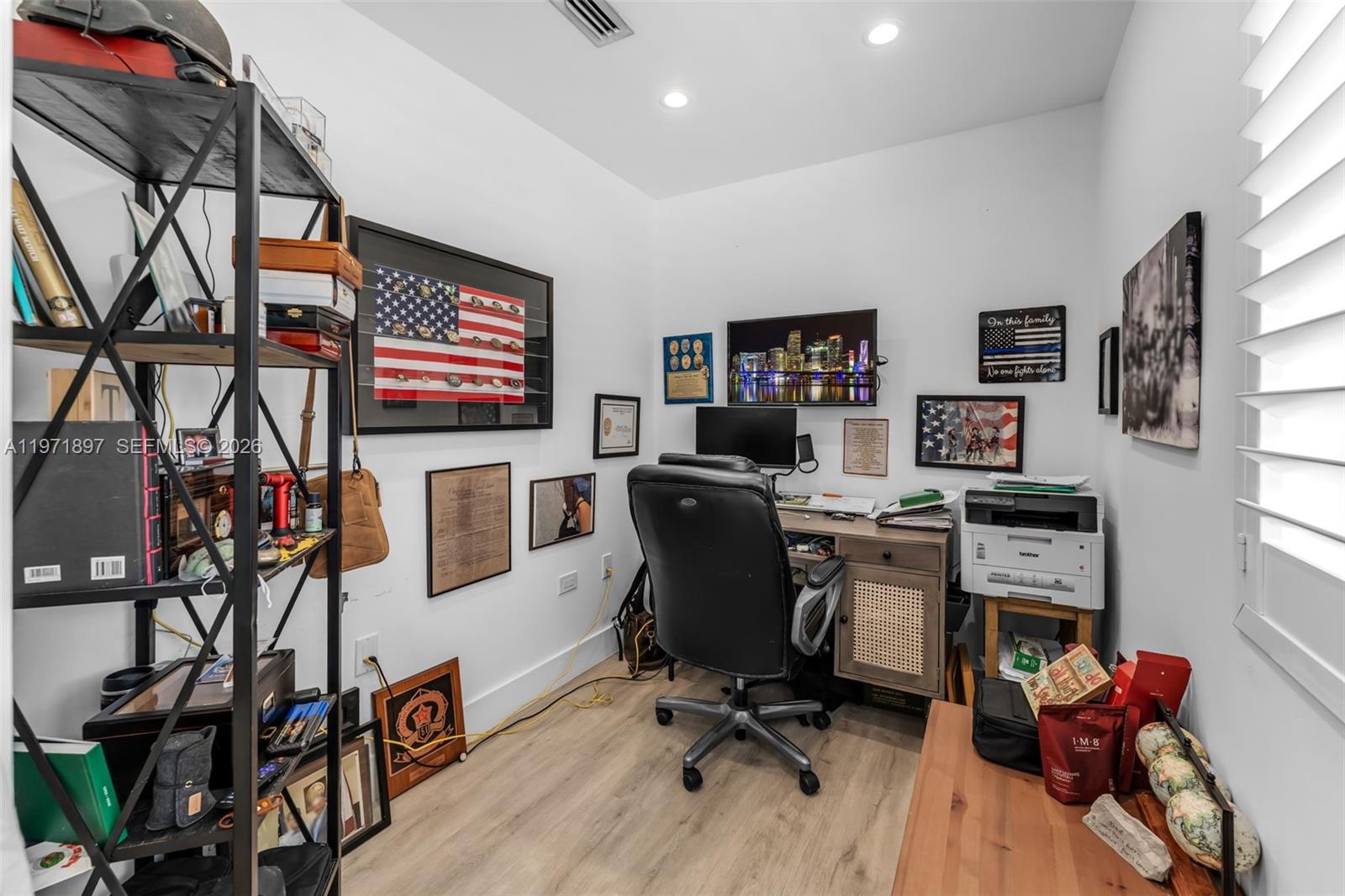 8311 Southwest 47th Street Miami, FL 33155 - Photo 18 of 48 a view of a workspace with furniture and a flat screen tv