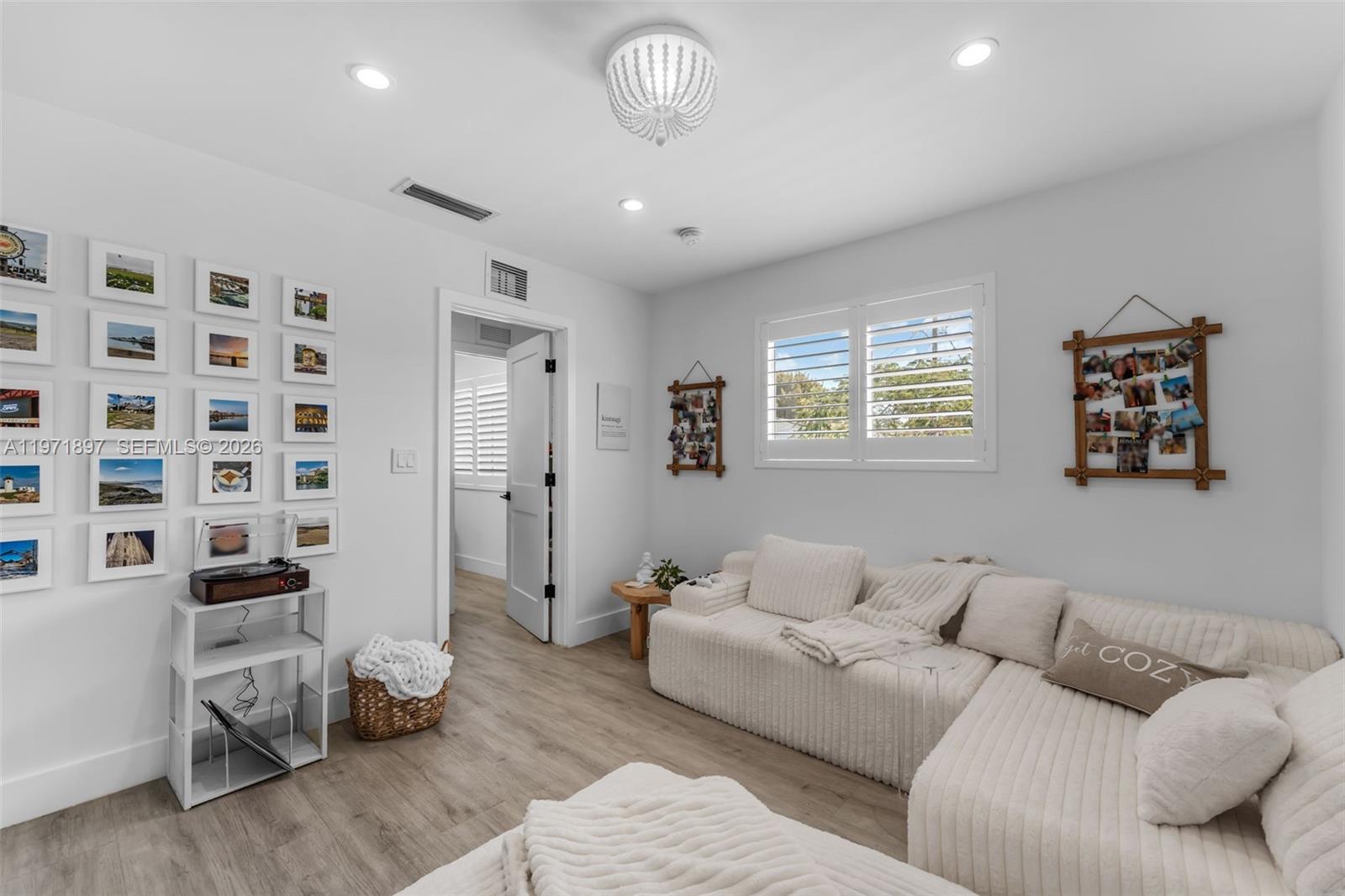 8311 Southwest 47th Street Miami, FL 33155 - Photo 20 of 48 a living room with furniture and a chandelier