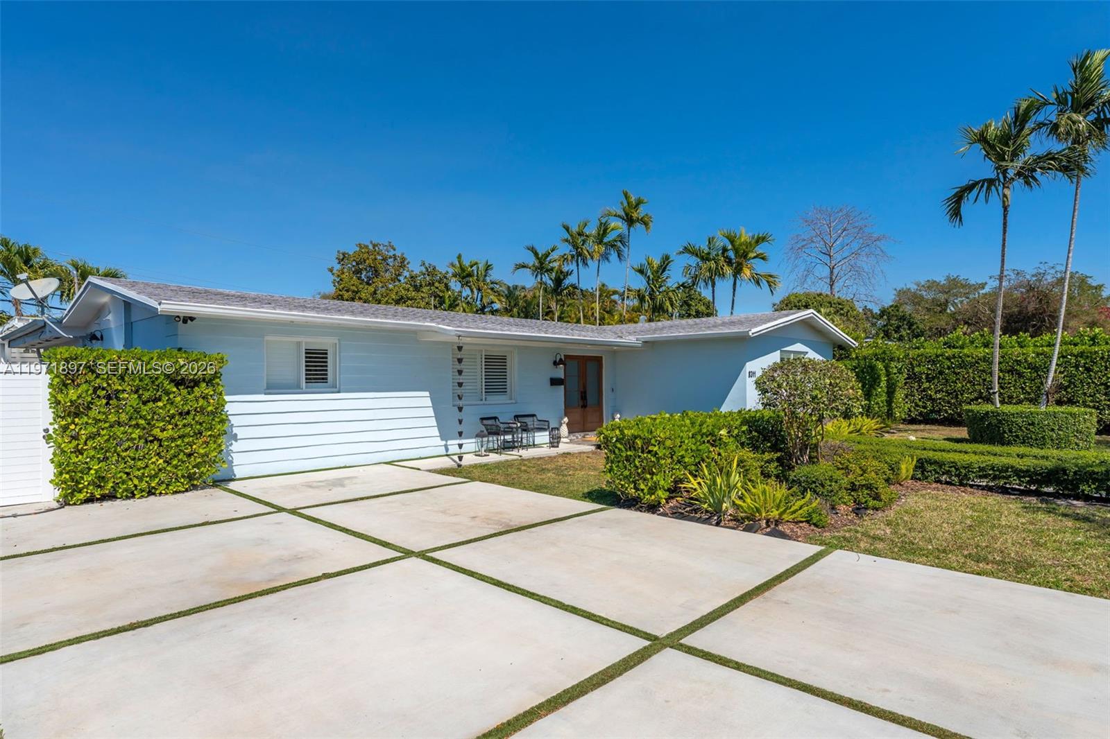 8311 Southwest 47th Street Miami, FL 33155 - Photo 2 of 48 a house with a yard and a lot of potted plants